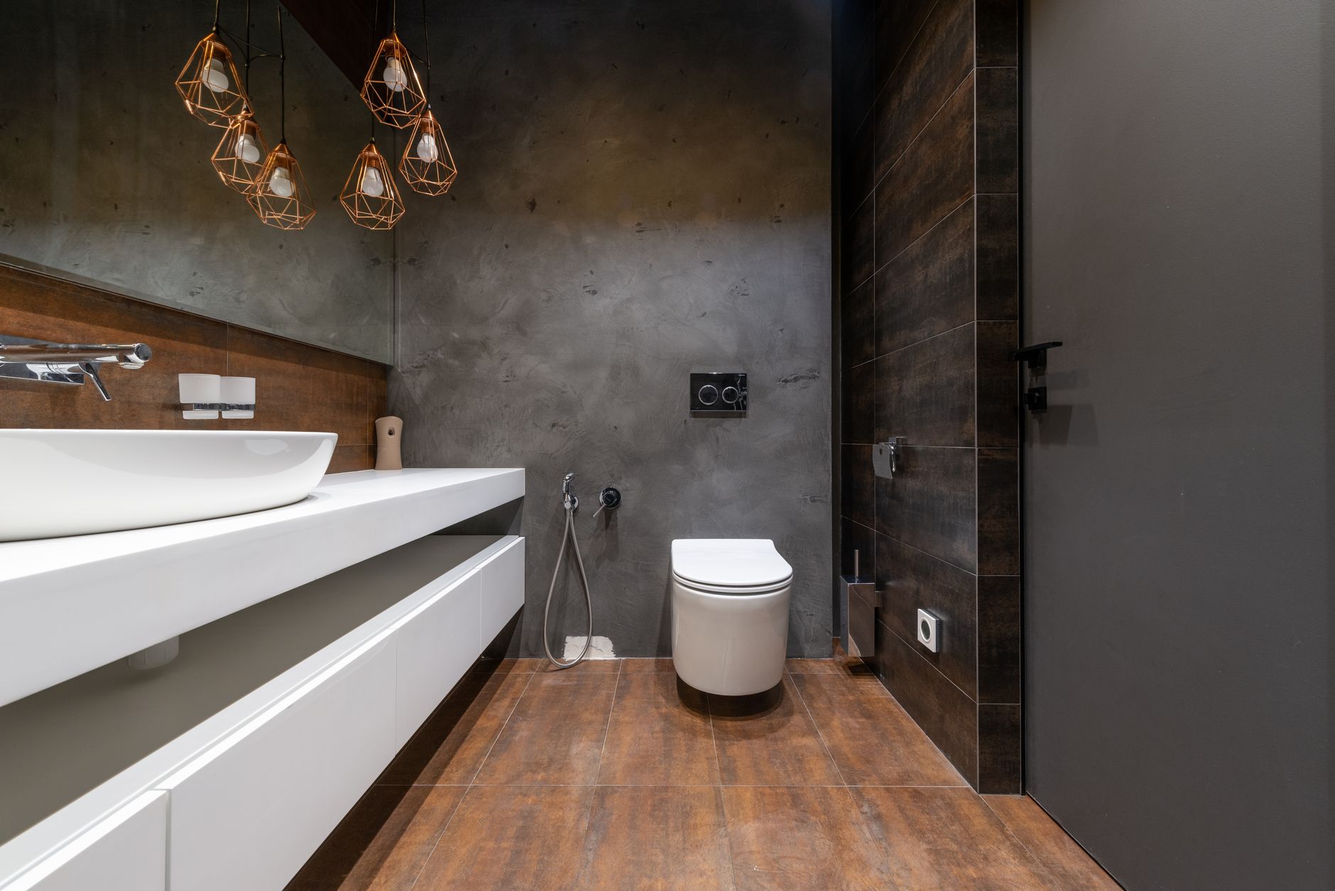 Sleek modern bathroom featuring a minimalist sink and elegant hanging lights in Riverside, CA