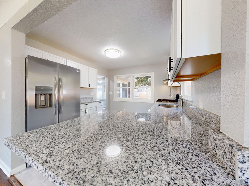 Light-filled room with a polished stone surface and large windows